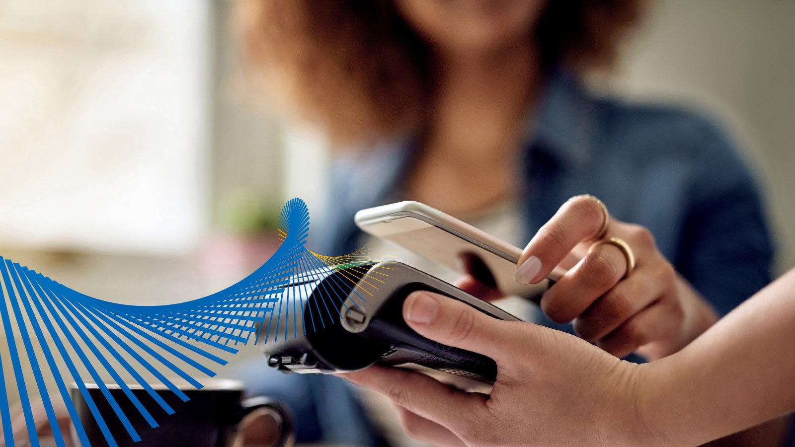 Woman paying with her mobile phone at a retailer.